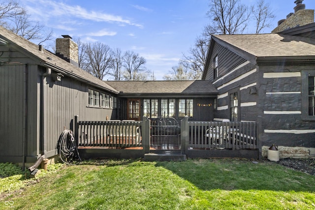 2790 W 50th St, Marion, IN 46953 - back of property featuring roof with shingles, a wooden deck, a chimney, and a yard
