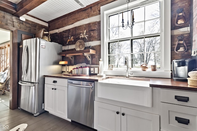2790 W 50th St, Marion, IN 46953 - kitchen with dark wood-style flooring, beam ceiling, a sink, stainless steel appliances, and white cabinetry