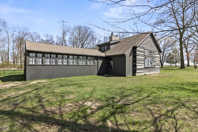 2790 W 50th St, Marion, IN 46953 - view of home's exterior featuring a shingled roof, a chimney, and a yard