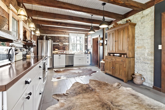 2790 W 50th St, Marion, IN 46953 - kitchen with stainless steel appliances, beam ceiling, white cabinetry, and a sink