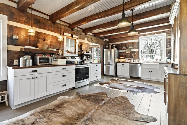 2790 W 50th St, Marion, IN 46953 - kitchen with white cabinets, dark countertops, appliances with stainless steel finishes, a sink, and decorative light fixtures