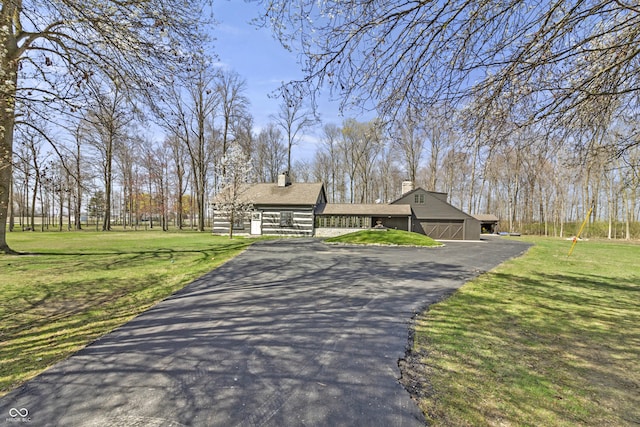 2790 W 50th St, Marion, IN 46953 - view of front of home featuring a chimney, a front yard, and aphalt driveway