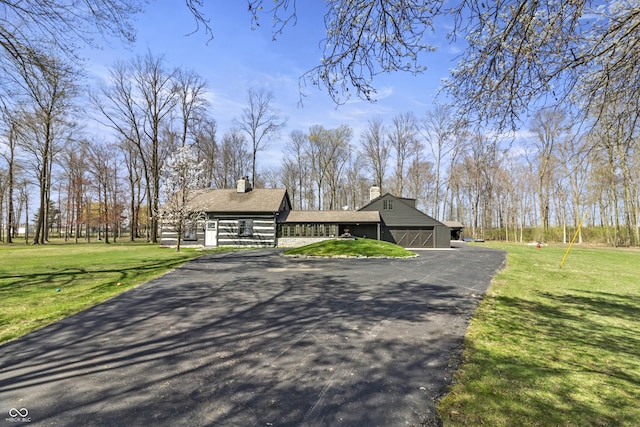 2790 W 50th St, Marion, IN 46953 - view of front of property featuring a chimney, an outdoor structure, a front yard, and aphalt driveway