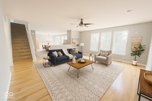 3724 Jonathan Rdg, Columbus, IN 47201 - living area with stairs, light wood-style floors, healthy amount of natural light, and ceiling fan