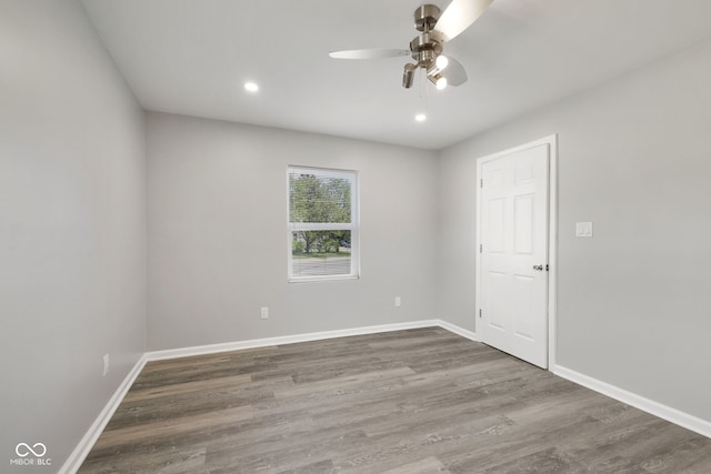 empty room with baseboards, a ceiling fan, wood finished floors, and recessed lighting