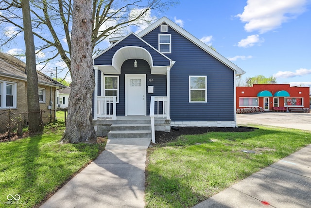 bungalow-style home featuring a front yard