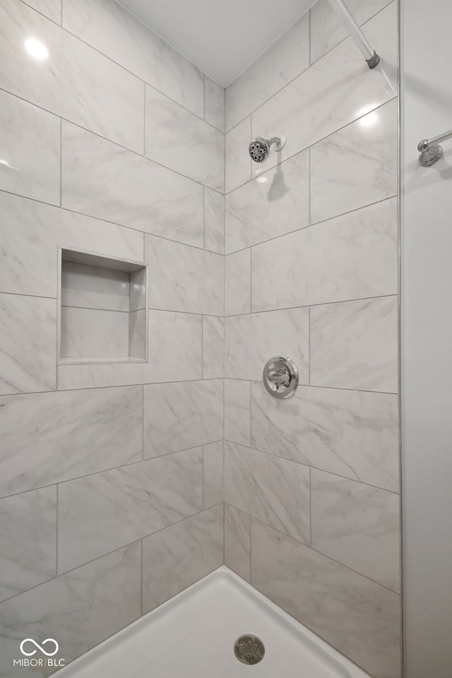 full bathroom with tiled shower