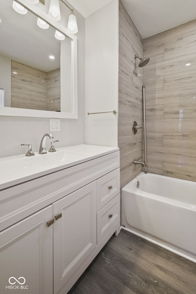 full bathroom featuring tub / shower combination, wood finished floors, and vanity