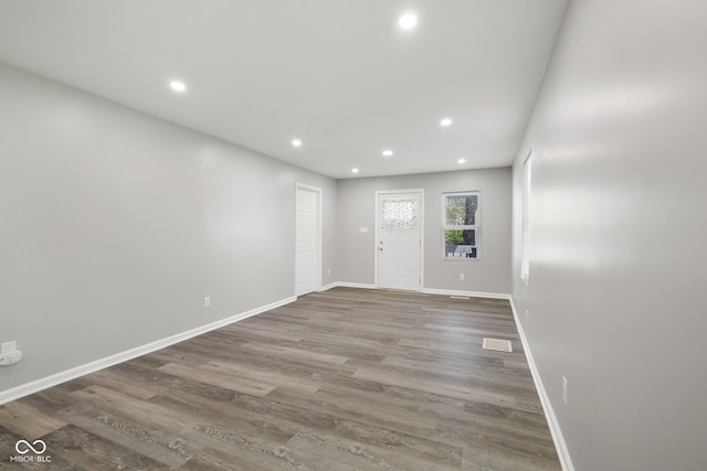 entrance foyer featuring baseboards, recessed lighting, and wood finished floors