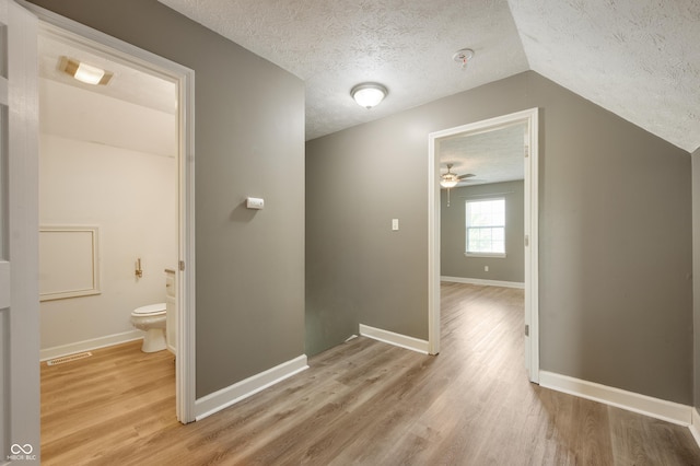 4786 N Mill Ct, Greenfield, IN 46140 - hall with a textured ceiling, light wood finished floors, baseboards, and vaulted ceiling