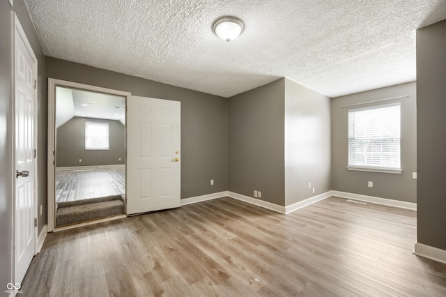 4786 N Mill Ct, Greenfield, IN 46140 - empty room with wood finished floors, baseboards, and a textured ceiling