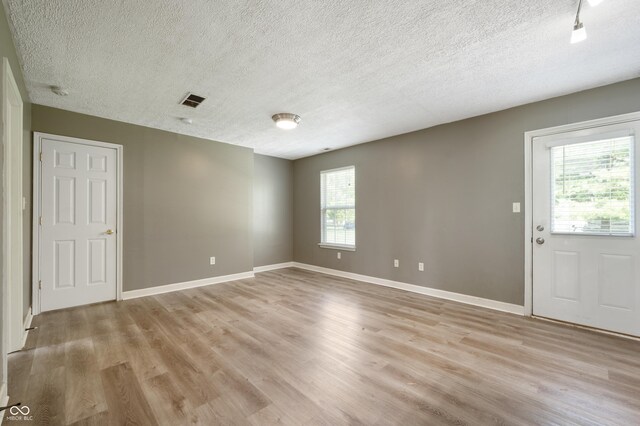 4786 N Mill Ct, Greenfield, IN 46140 - unfurnished room with light wood finished floors, a textured ceiling, and baseboards