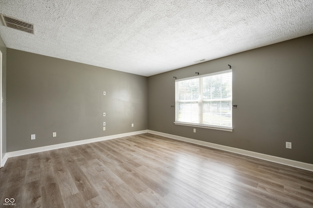 4786 N Mill Ct, Greenfield, IN 46140 - spare room with a textured ceiling, wood finished floors, and baseboards