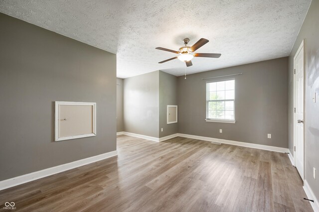 4786 N Mill Ct, Greenfield, IN 46140 - empty room featuring wood finished floors, a ceiling fan, a textured ceiling, and baseboards