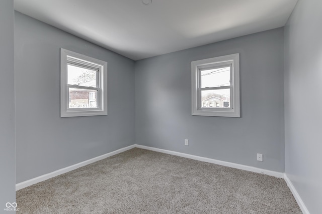 spare room featuring baseboards and carpet