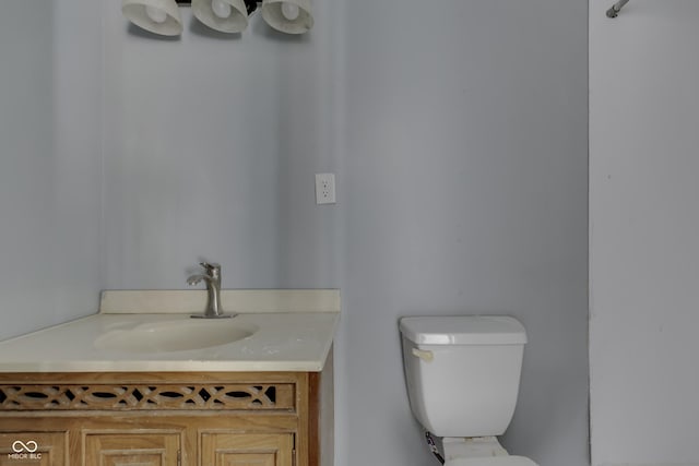 half bath featuring toilet and vanity