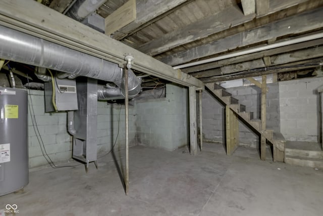 unfinished below grade area with stairway, electric water heater, and visible vents