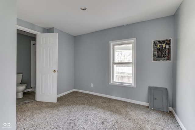 unfurnished bedroom with baseboards, carpet, and connected bathroom