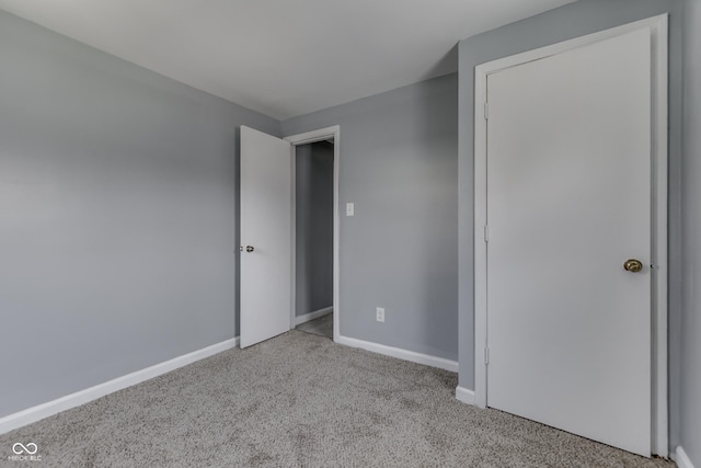 unfurnished bedroom with baseboards and carpet flooring