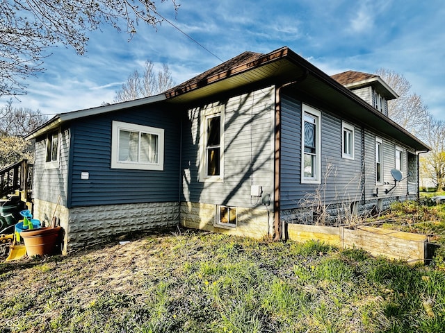 view of property exterior featuring a vegetable garden