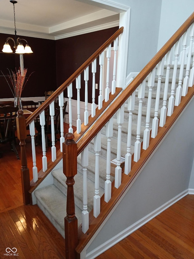5983 Clearview Dr, Carmel, IN 46033 - stairway featuring wood finished floors, an inviting chandelier, and baseboards