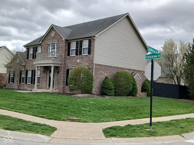 5983 Clearview Dr, Carmel, IN 46033 - view of front facade featuring a shingled roof, a front yard, fence, and brick siding