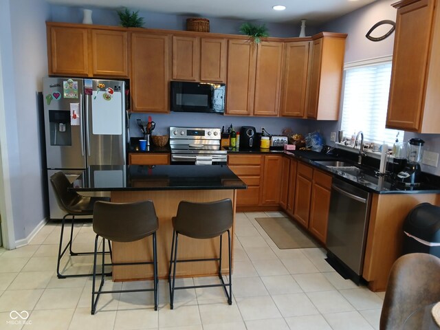 5983 Clearview Dr, Carmel, IN 46033 - kitchen featuring a center island, a sink, dark countertops, a kitchen bar, and stainless steel appliances