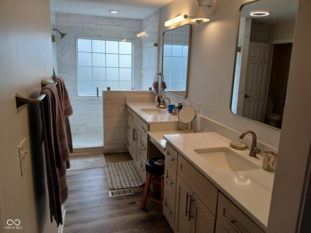 5983 Clearview Dr, Carmel, IN 46033 - full bathroom featuring tiled shower, a sink, and wood finished floors