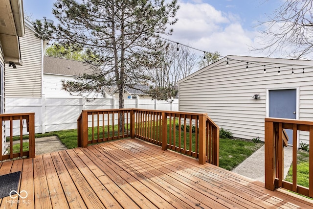 deck with a yard and a fenced backyard
