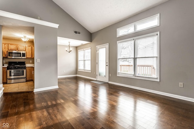 unfurnished living room with baseboards, visible vents, a chandelier, hardwood / wood-style flooring, and high vaulted ceiling