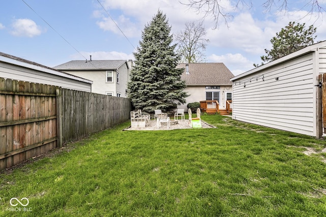 view of yard featuring a wooden deck, a fenced backyard, and a patio