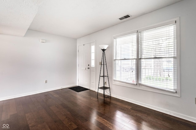 entryway featuring visible vents, baseboards, and wood-type flooring