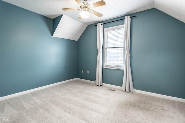 bonus room featuring lofted ceiling, a ceiling fan, visible vents, and carpet floors