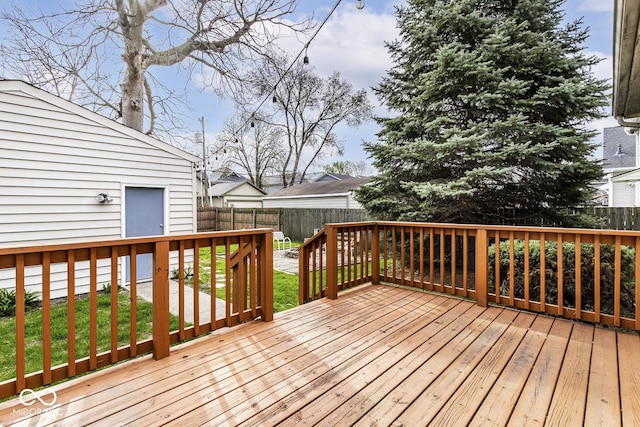 wooden terrace featuring a fenced backyard and a yard