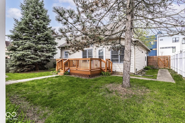 view of front of property featuring a fenced backyard, a deck, and a front yard