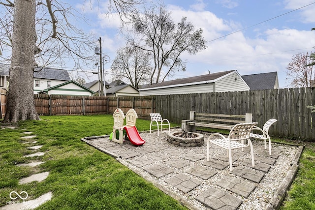 view of yard featuring a fenced backyard, a patio area, and an outdoor fire pit