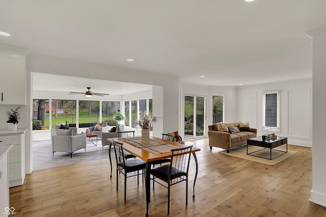 dining space featuring light wood-style floors, a wealth of natural light, and ceiling fan