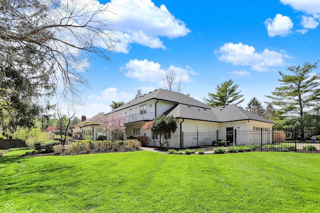 exterior space featuring fence, a lawn, and a chimney