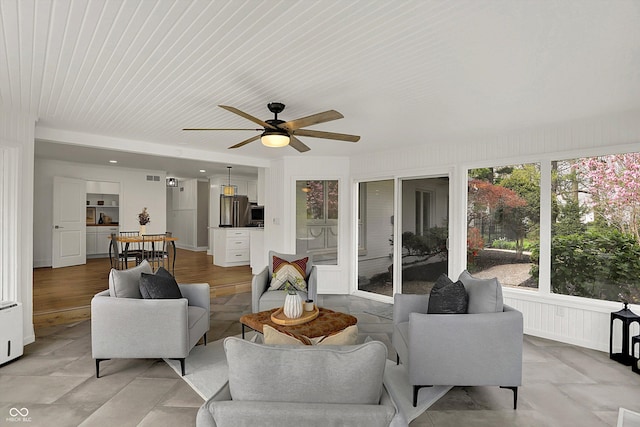 living room featuring visible vents and ceiling fan