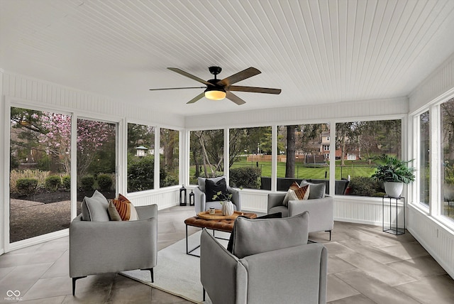 sunroom featuring a ceiling fan and outdoor lounge area