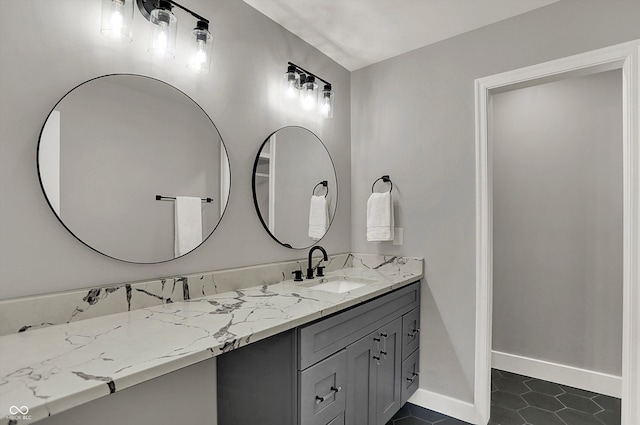 bathroom featuring tile patterned floors, baseboards, and vanity