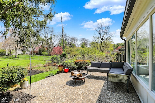 view of patio featuring fence and an outdoor living space with a fire pit