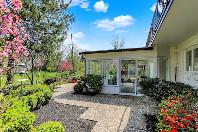 exterior space with brick siding and a patio