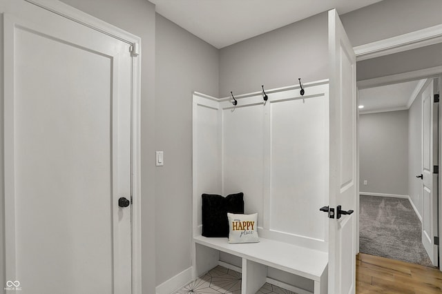 mudroom with baseboards and light wood-type flooring