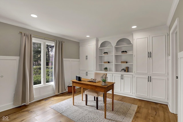 home office featuring crown molding, light wood-type flooring, and plenty of natural light
