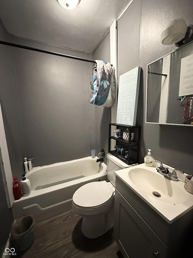 full bathroom with toilet, shower / tub combination, vanity, and wood finished floors