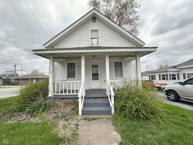 shotgun-style home featuring covered porch