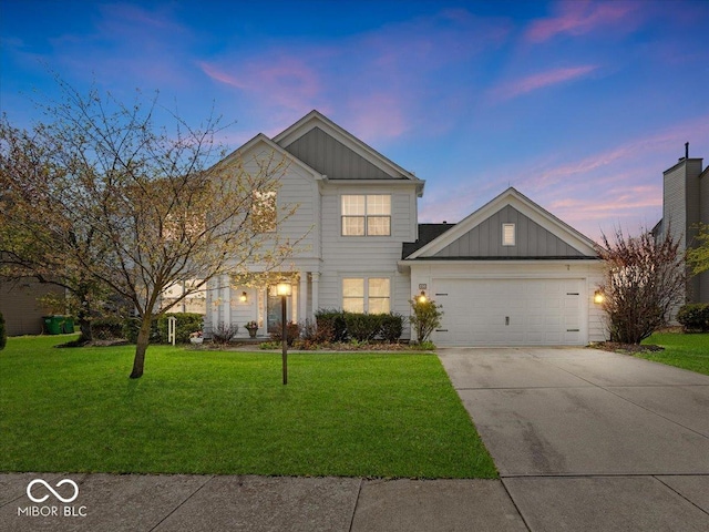 view of front of property with concrete driveway, board and batten siding, a garage, and a lawn