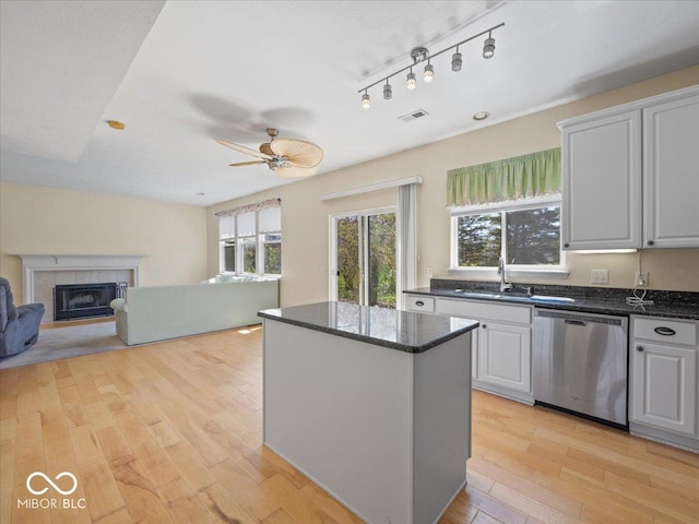 kitchen with a wealth of natural light, a sink, visible vents, and stainless steel dishwasher