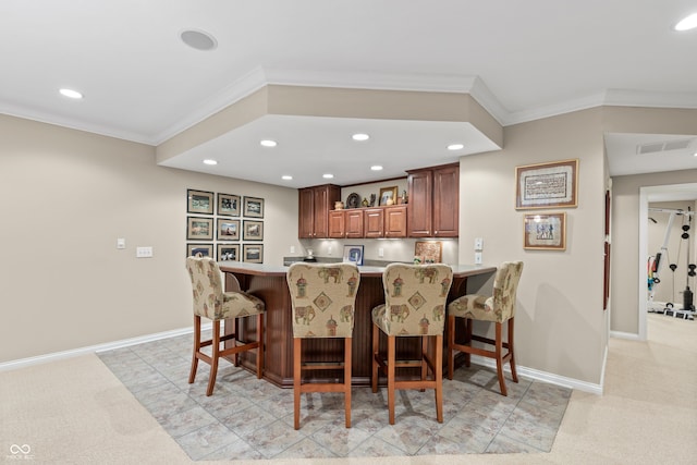 bar with ornamental molding, indoor wet bar, and recessed lighting